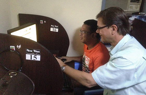 U Sein Win, Training Director at the Myanmar Journalism Institute, discusses the options for e-learning in media training programs with Interlink's Werner Eggert at an internet cafÃ© in Yangon